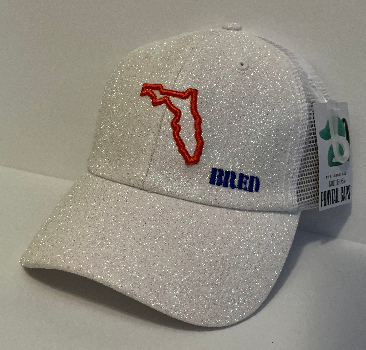 White Glitter Ponytail with Orange/Blue Logo